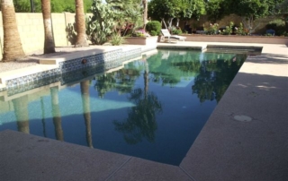 Before: rectangular pool with its original tile and concrete decking