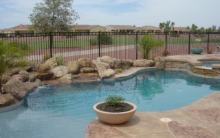 DSC00181 Freeform pool with a rock waterfall and planter island beside a golf course
