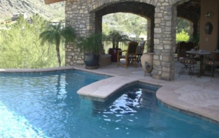 Pendergraft (3) Pool with a bridge and a stone-arch patio with mountain views