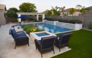 11 Patio seating around a fire table beside a pool with sheer descents and a pergola