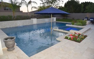 13 Pool with a sun shelf umbrella, raised planter and travertine decking