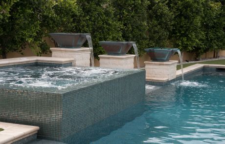 Raised glass-tile spa with water bowls on pedestals