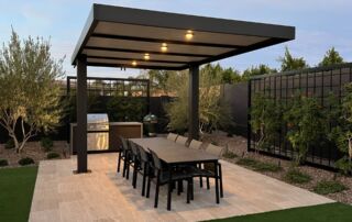 IMG_4483 Lit pergola over an outdoor dining table and grill on a travertine patio