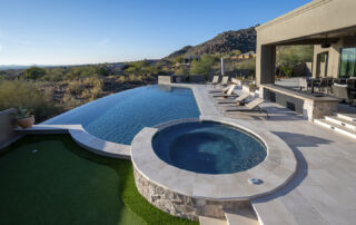 Overflow Pools-Bryant-2-LR Vanishing-edge pool and round spa beside a putting green with a mountain view