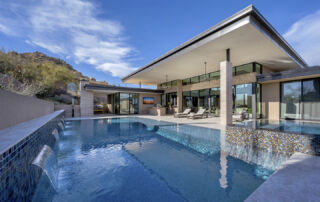 Modern home with an infinity-edge pool and mosaic-tile spa